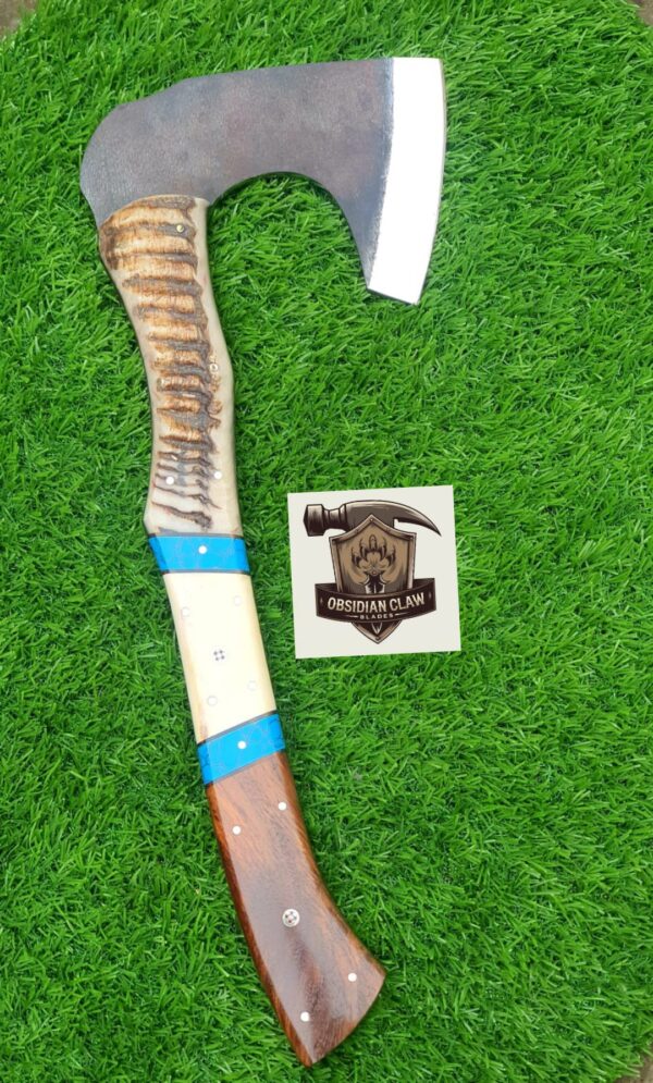 Handmade 1095 high carbon steel vikings  throwing hatchet  with leather cover. 
Handle made with the combination  of ram horn and camel bone and rose wood scales . Blue Turkish spacers.  Approximately  17 inches long.
6 inches head width. - Image 2