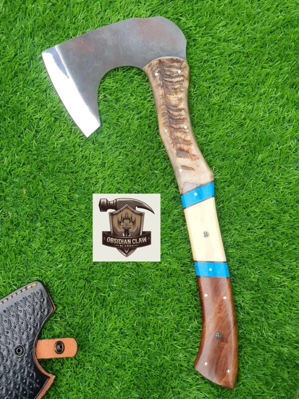 Handmade 1095 high carbon steel vikings  throwing hatchet  with leather cover. 
Handle made with the combination  of ram horn and camel bone and rose wood scales . Blue Turkish spacers.  Approximately  17 inches long.
6 inches head width.