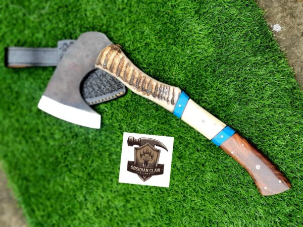 Handmade 1095 high carbon steel vikings  throwing hatchet  with leather cover. 
Handle made with the combination  of ram horn and camel bone and rose wood scales . Blue Turkish spacers.  Approximately  17 inches long.
6 inches head width. - Image 3