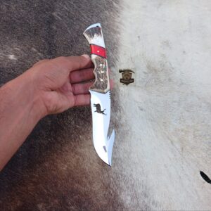 Gut hook knife with leather sheath.