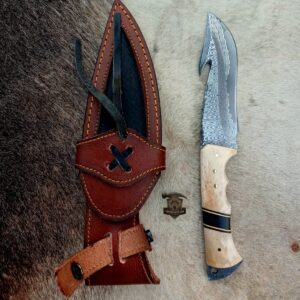 Damascus steel gut hook knife with leather sheath.