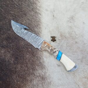 Damascus steel gut hook knife with leather sheath.