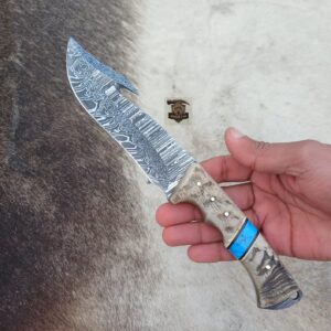 Handmade Damascus steel gut hook knife with leather sheath.