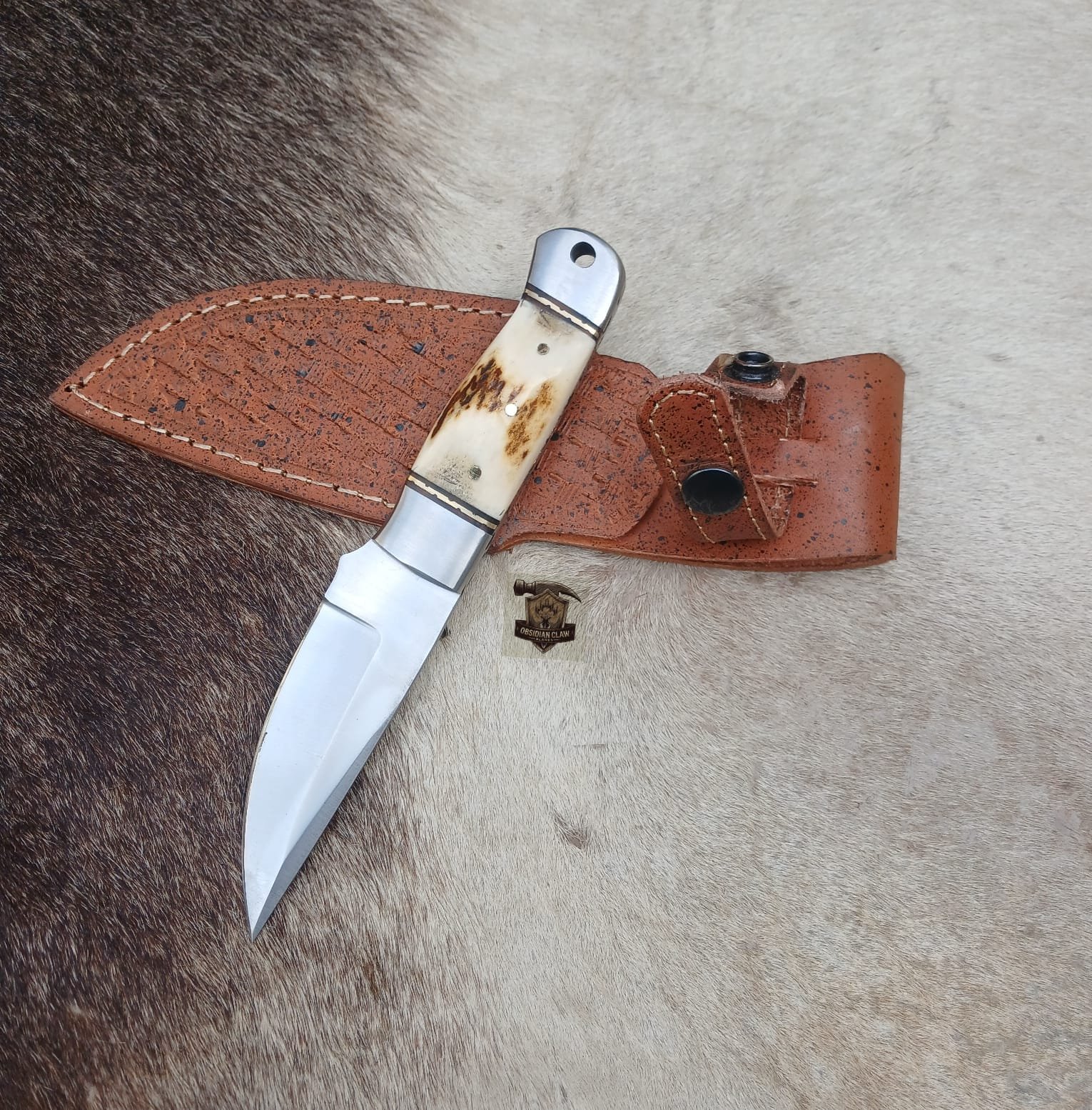 Skinner knife with leather sheath.