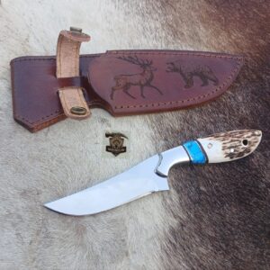 Skinner knife with leather sheath.